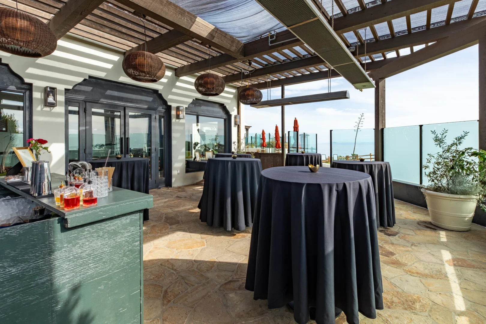 The bluff-top terrace at golden hour, overlooking the ocean
